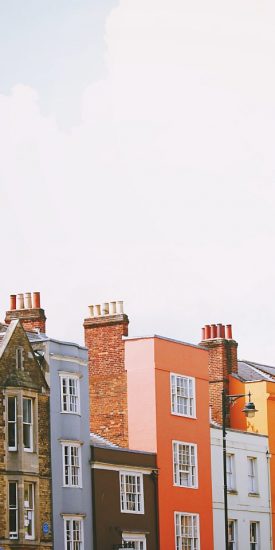 Photo showing the top of a row of colourful houses